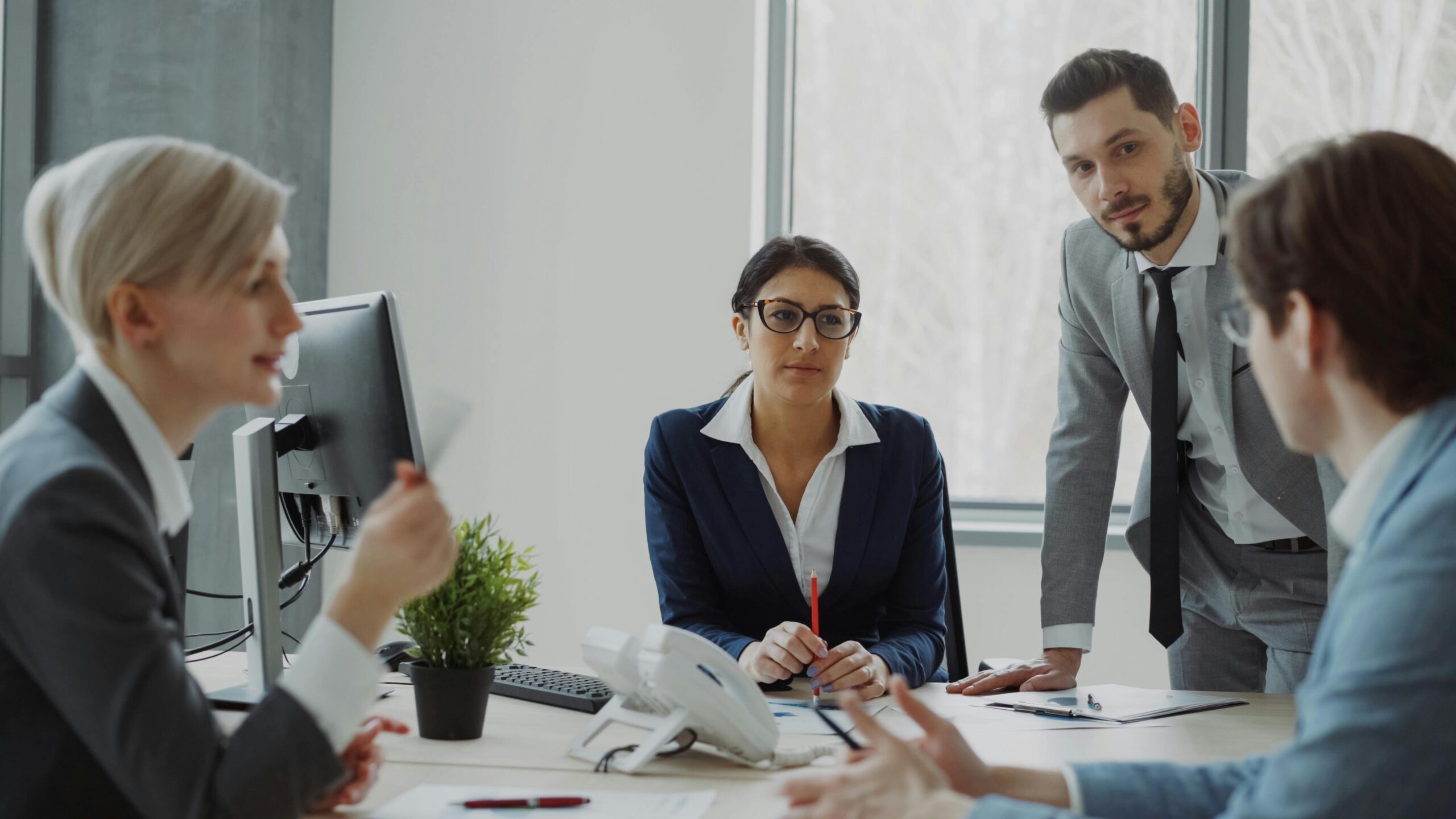 Professionals engaged in a business meeting in a contemporary office environment.